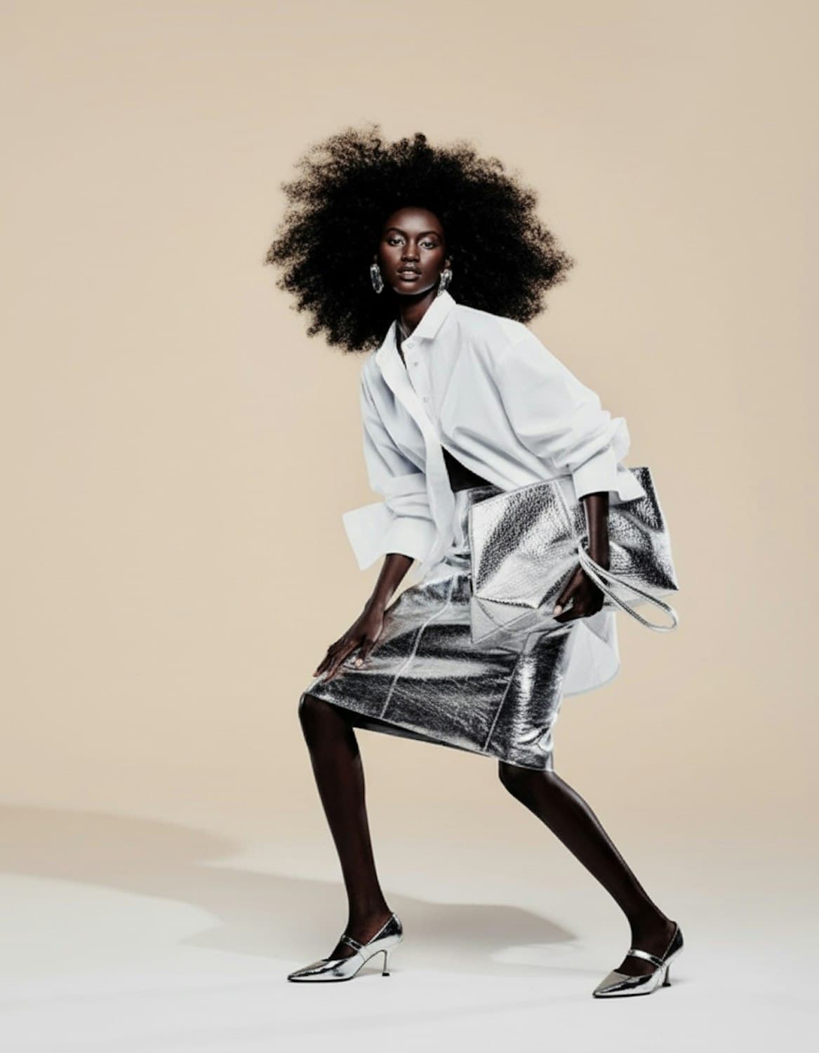 Oversized white shirt over a metallic silver pencil skirt, with a silver bag and silver pumps