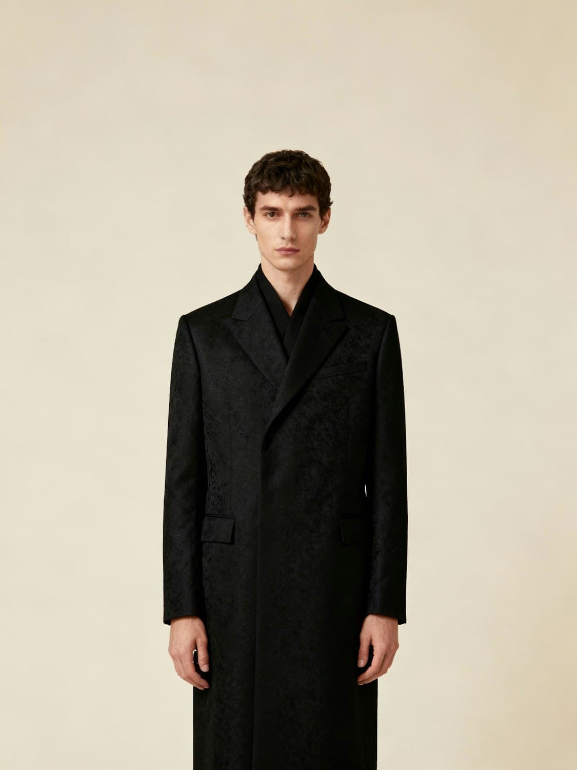 Male model in a long black jacquard double-breasted coat